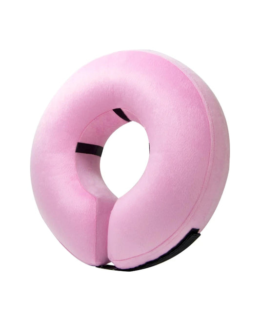 a pink pillow with a black strap