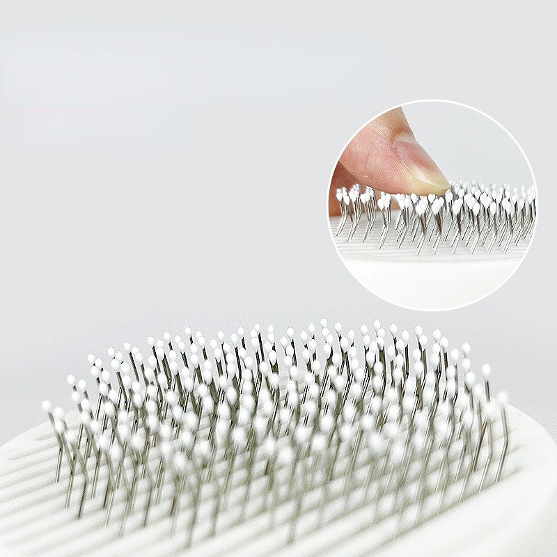 a close-up of a finger touching a hair brush