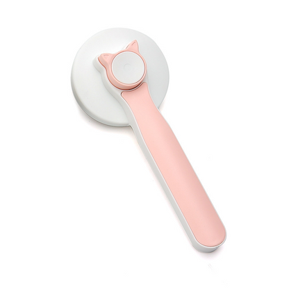 a pink and white plastic pizza cutter